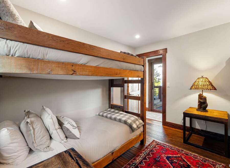 This cozy bedroom features a rustic bunk bed, perfect for accommodating guests or family.