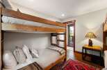 This cozy bedroom features a rustic bunk bed, perfect for accommodating guests or family.