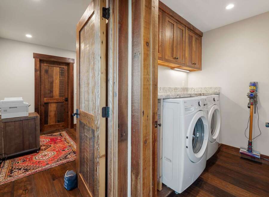 Step into this beautifully designed laundry room, featuring a modern washer and dryer set.