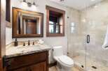 This stunning bathroom boasts a rustic charm with its wooden accents and elegant design.