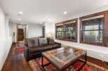 This stunning living room boasts a cozy leather sofa and plush pillows, perfect for relaxing after a long day.