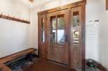 Step into luxury with this stunning entryway featuring a beautiful wooden door and sidelights.