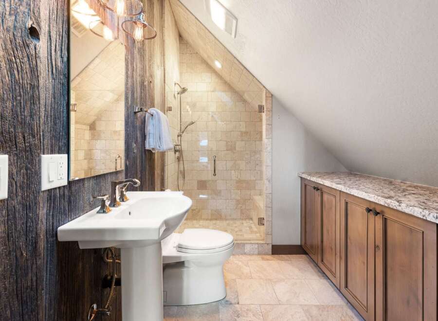 This stunning bathroom boasts rustic charm with its reclaimed wood accents and a modern touch.
