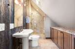 This stunning bathroom boasts rustic charm with its reclaimed wood accents and a modern touch.