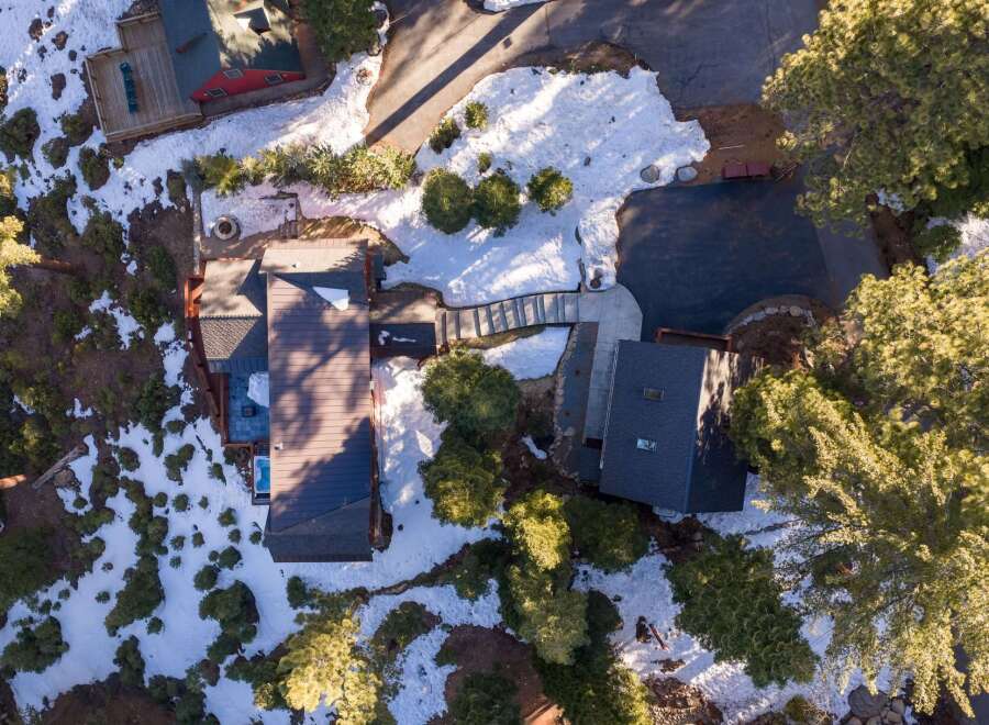 Nestled amidst a snowy landscape, this stunning property boasts a modern design with a touch of rustic charm.