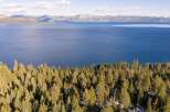 Experience breathtaking views of the lake and mountains from this stunning property.