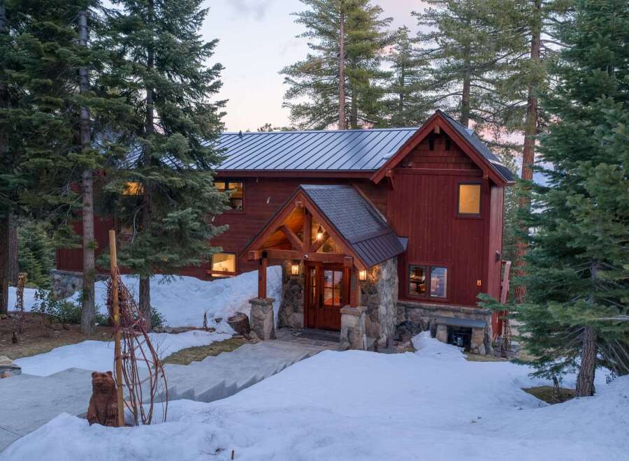 Nestled amidst towering pines, this stunning mountain home offers a serene escape.