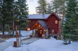 Nestled amidst towering pines, this stunning mountain home offers a serene escape.