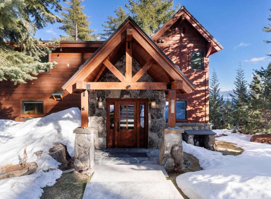 This stunning mountain home boasts a beautiful wooden exterior and a welcoming entrance.