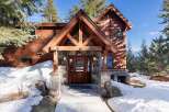 This stunning mountain home boasts a beautiful wooden exterior and a welcoming entrance.