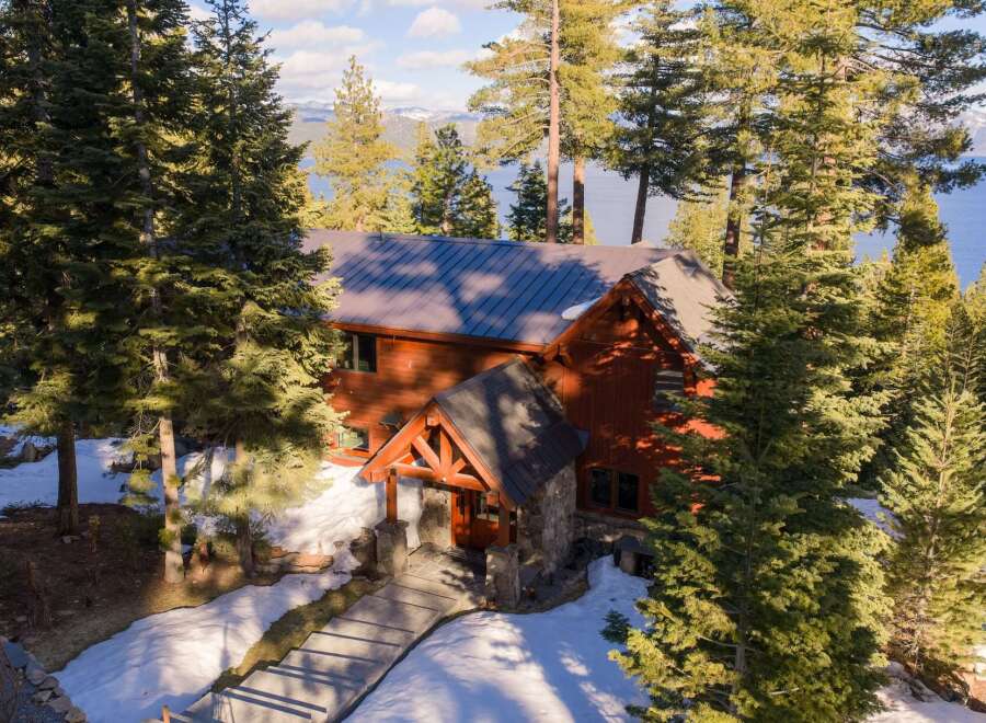 Nestled amidst towering trees and overlooking a serene lake, this stunning property offers a perfect blend of natural beauty and luxurious living.