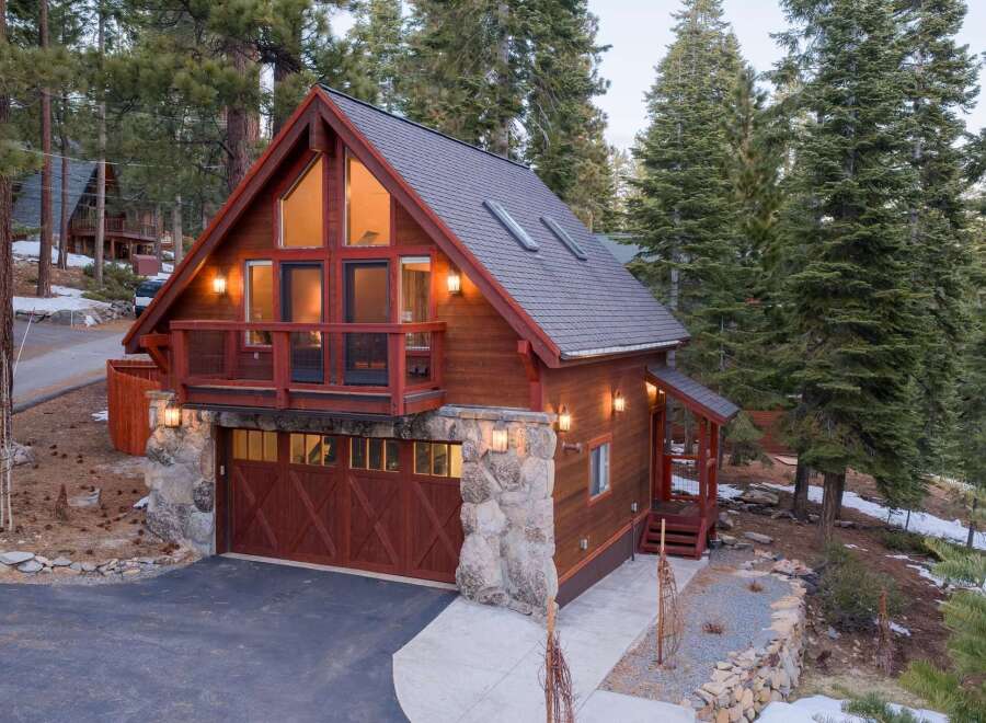 This stunning cabin-style home offers a perfect blend of rustic charm and modern convenience.