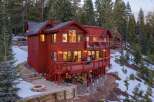 Nestled amidst a serene forest, this stunning property boasts a striking red exterior and a multi-level design.
