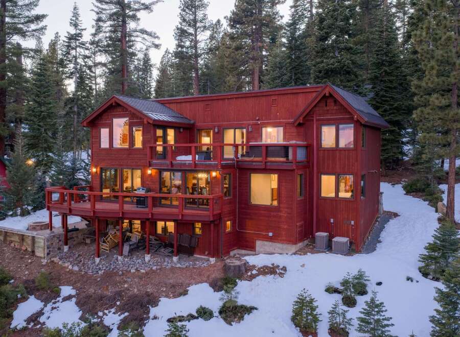 Nestled in a serene forest setting, this stunning property boasts a multi-level design with expansive decks, perfect for enjoying the surrounding natural beauty.