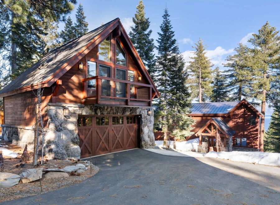 This stunning mountain home boasts a rustic charm with its wooden exterior and stone accents.