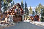 This stunning mountain home boasts a rustic charm with its wooden exterior and stone accents.