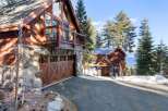 This stunning mountain home boasts a beautiful exterior with a combination of wood and stone.