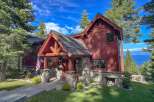 Experience breathtaking lake views from this stunning mountain retreat, nestled amongst towering pine trees.