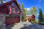 Experience luxury mountain living in this stunning timber-frame home, featuring a spacious garage and a charming covered entryway.