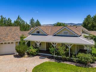 Discover this charming home featuring a welcoming covered porch perfect for enjoying the outdoors.