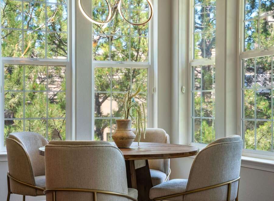 Enjoy your morning coffee in this charming breakfast nook, bathed in natural light from large, grid-pane windows.