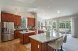 This spacious kitchen boasts rich cherry wood cabinetry and gleaming marble countertops, perfect for the home chef.