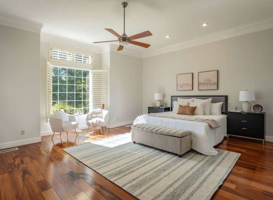 Experience luxurious comfort in this stunning bedroom, featuring a spacious king-size bed adorned with plush pillows and a cozy throw.