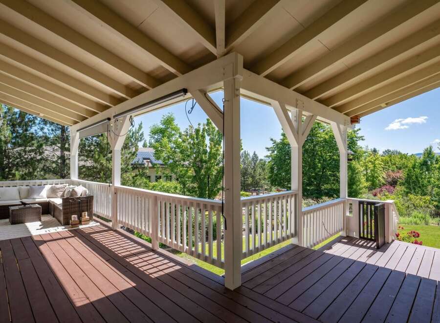 Enjoy outdoor living on this spacious covered deck, perfect for entertaining or relaxing.