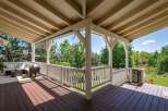 Enjoy outdoor living on this spacious covered deck, perfect for entertaining or relaxing.