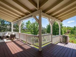 Enjoy outdoor living on this spacious covered deck, perfect for entertaining or relaxing.