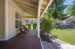 Enjoy relaxing evenings on this charming covered porch, complete with two Adirondack chairs and a cozy rug.