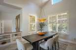 This elegant dining room features a dark wood dining table with upholstered chairs, perfect for hosting gatherings.