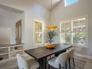 This elegant dining room features a dark wood dining table with upholstered chairs, perfect for hosting gatherings.