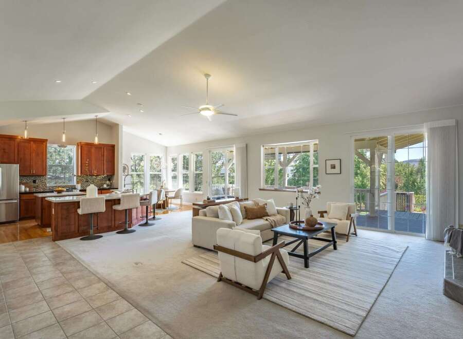 Experience open-concept living in this stunning home featuring a spacious kitchen with a large island and bar seating, perfect for entertaining.