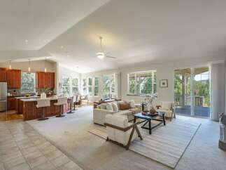 Experience open-concept living in this stunning home featuring a spacious kitchen with a large island and bar seating, perfect for entertaining.
