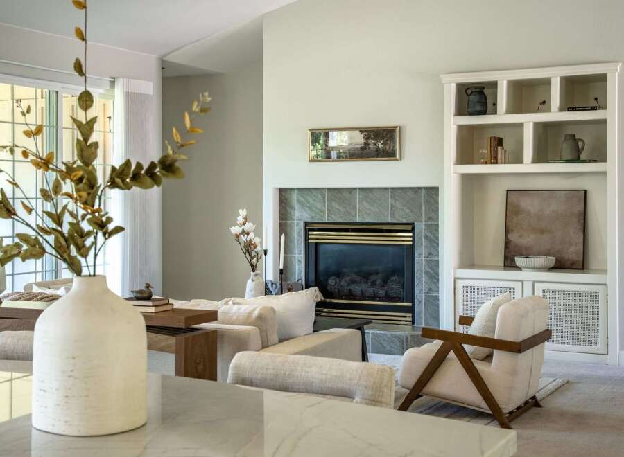 Experience modern comfort in this beautifully appointed living room, featuring a sleek fireplace as the focal point.