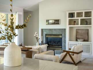 Experience modern comfort in this beautifully appointed living room, featuring a sleek fireplace as the focal point.