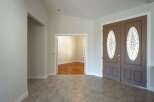 Step into a welcoming entryway featuring elegant double doors with decorative glass panels.