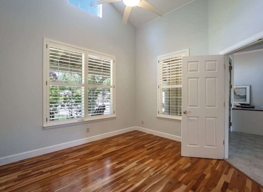 Step into this inviting room featuring gleaming hardwood floors and abundant natural light.