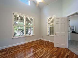 Step into this inviting room featuring gleaming hardwood floors and abundant natural light.