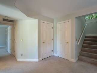 Discover comfortable living in this home featuring a well-lit hallway with multiple doors leading to various rooms.