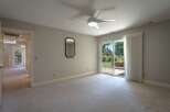 Step into this spacious bedroom featuring plush carpeting and a modern ceiling fan for ultimate comfort.