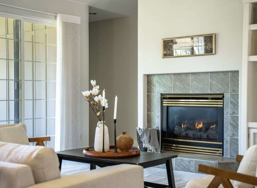 Cozy living room featuring a gas fireplace with a marble tile surround, perfect for chilly evenings.