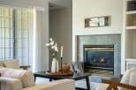 Cozy living room featuring a gas fireplace with a marble tile surround, perfect for chilly evenings.