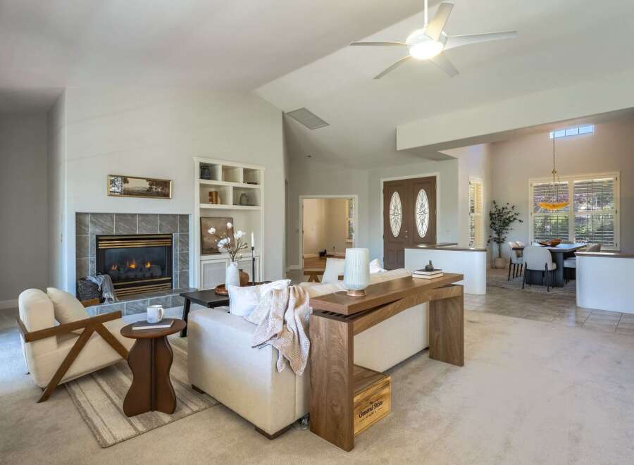 Step into this inviting living space featuring a cozy fireplace and ample natural light.