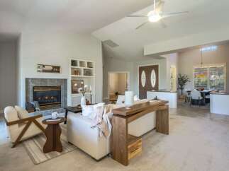 Step into this inviting living space featuring a cozy fireplace and ample natural light.