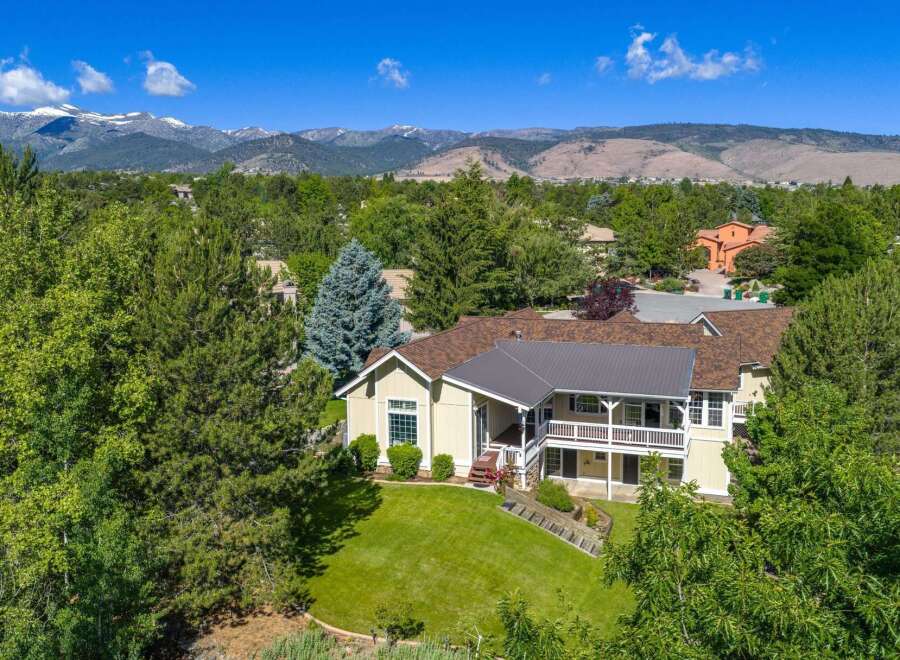 Nestled amidst lush greenery and mature trees, this stunning property offers a serene retreat with breathtaking mountain views.