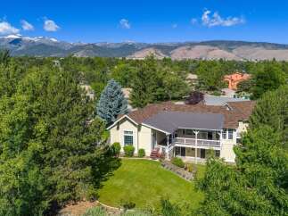 Nestled amidst lush greenery and mature trees, this stunning property offers a serene retreat with breathtaking mountain views.