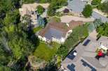 Discover this stunning aerial view of a sprawling estate, showcasing a magnificent home with a complex roofline and expansive grounds.