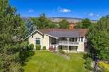Nestled amidst mature trees and offering stunning mountain views, this charming home boasts a spacious multi-level deck perfect for entertaining or enjoying the serene surroundings.